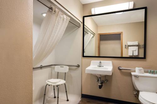 a bathroom with a sink and a mirror at Best Western Grove City Inn in Grove City