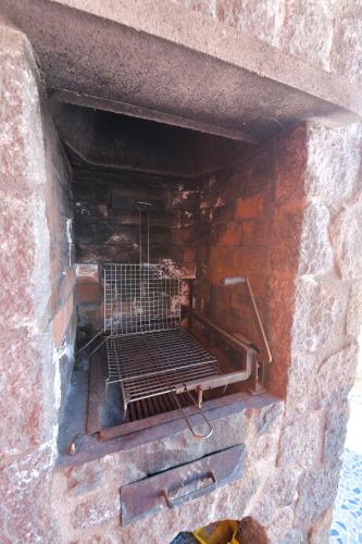 a brick oven with a metal grate in it at Villa Stefania in Ischia