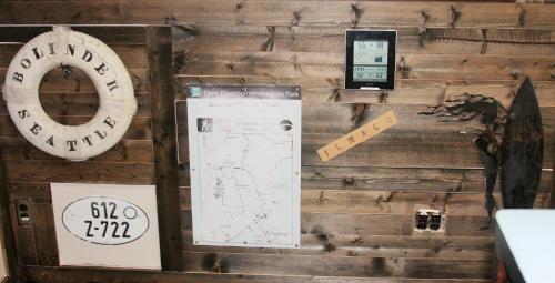 a wall with signs and a map and a clock at Heidi's Inn in Ilwaco