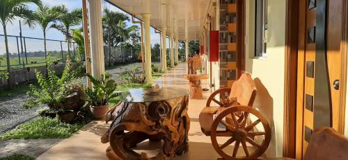 a wooden cart sitting on a porch with a table at Binalonan Transient/GUESTHOUSE (PENSION GLAYDIE) in Binalonan
