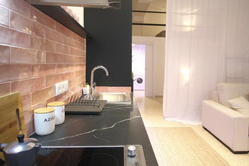 a kitchen with a sink and a counter top at Loft de lujo a estrenar Apartamento n2 in Valencia