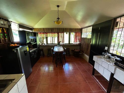 a kitchen with a table in the middle of it at Eco Villas Tambor Tucanes in Tambor