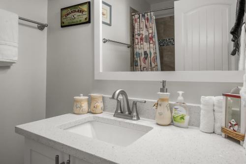 a bathroom counter with a sink and a mirror at Beautiful Beach House w/Ocean View! Ocean Lakes SC in Myrtle Beach