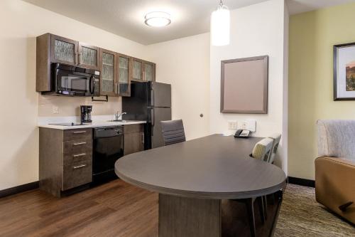 a small kitchen with a table in a room at Candlewood Suites Portland Airport by IHG in Portland