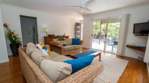 a living room with a couch and a table at Dolphin Escape Holiday House in Horseshoe Bay
