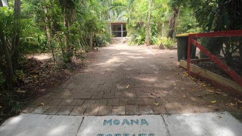 a path in the middle of a forest with a gate at Moana Cottage, Stroll To Horseshoe Bay Beachfront in Horseshoe Bay