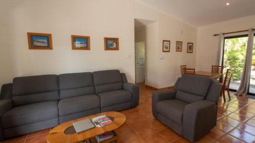 a living room with a couch and a table at The Ponderosa Holiday House in Horseshoe Bay