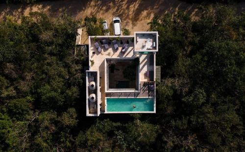 an overhead view of a house with a swimming pool at Yum Kaax Boutique Villa in Tulum