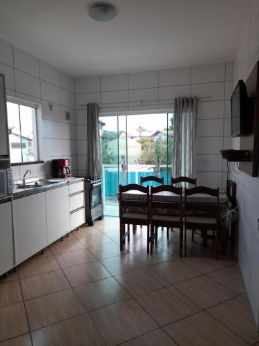 a kitchen with a table and chairs in a room at Apartamentos de Penha in Penha