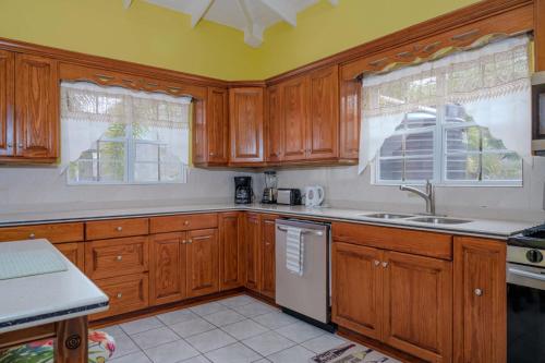 a kitchen with wooden cabinets and a white refrigerator at DD'S Vacation Property in Harveys