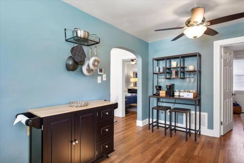 a kitchen with blue walls and a ceiling fan at Private House Mins to Maymont Park, Trails & VCU! in Richmond