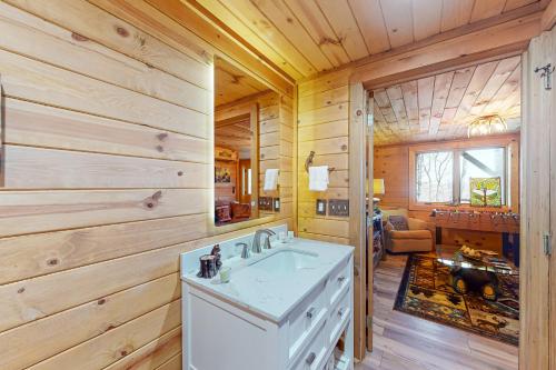 a bathroom with a sink in a log cabin at Rocksway Cabin in Banner Elk