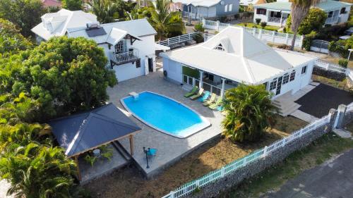 an aerial view of a house with a swimming pool at Villa MARIE-GALANTE -Sainte-Anne in Sainte-Anne