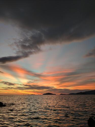 a sunset over a body of water at Cashewnut Cove in Ko Lipe