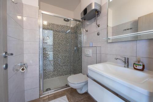 a bathroom with a shower and a toilet and a sink at Apartment Asja in Ivan Dolac