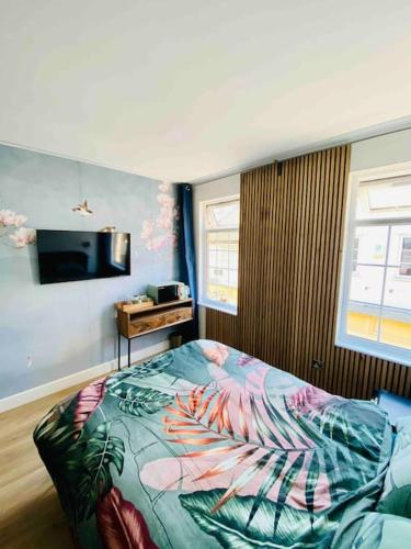 a bedroom with a bed and a television in it at New studio flat overlooking city centre in Kingston upon Thames