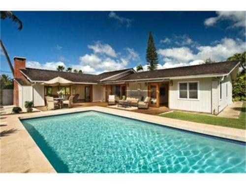 a swimming pool in front of a house at Best Vacation rental house close to Kahala Beach ! in Honolulu