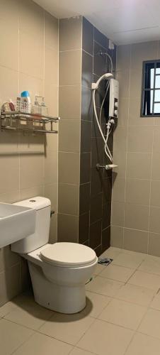 a bathroom with a toilet and a sink at Homestay Shah Alam (Residensi Alami) in Shah Alam