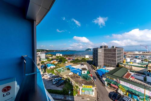 a view of a city from a balcony at BK Hotel Jeju in Seogwipo