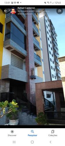 a screenshot of a building with a picture of it at apartamento pé na areia Mongaguá in Itanhaém