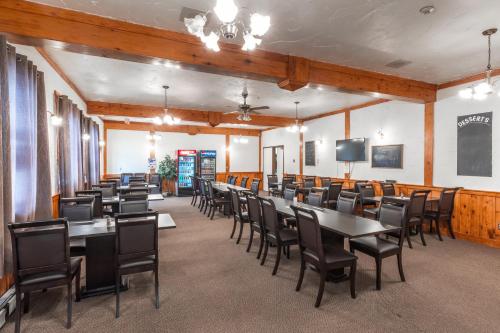 a large dining room with tables and chairs at Englehart Motel in Englehart