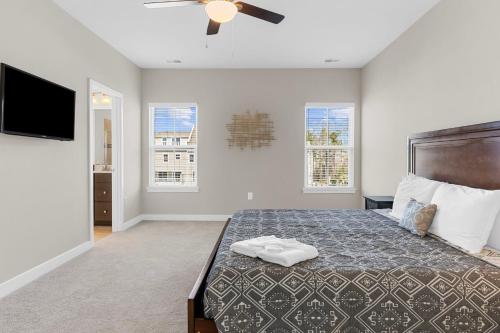 a bedroom with a bed and a flat screen tv at New 4 Bedroom Townhouse at Barefoot Resort in North Myrtle Beach