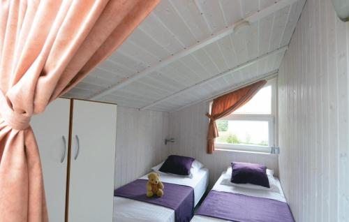 a room with two beds and a window at Strandblick 7 - Dorf 1 in Travemünde