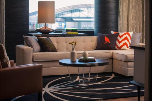 a living room with a couch and a table at Kimpton Hotel Palomar Phoenix Cityscape by IHG in Phoenix
