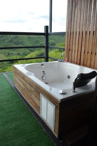 a bath tub in a room with a large window at GLAMPING CAFETOS in Montenegro