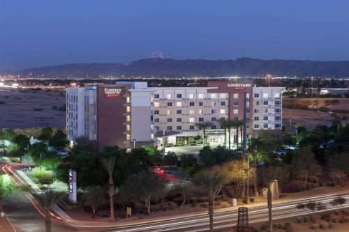 a large white building in a city at night at Fairfield Inn and Suites Phoenix Chandler Fashion Center in Chandler