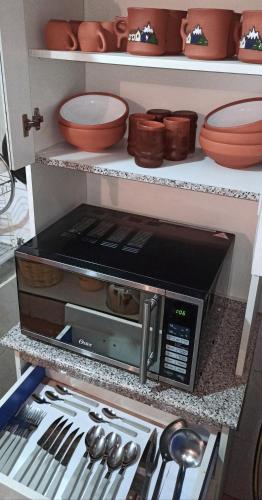 a kitchen with a toaster oven on a counter at The Little House ApartHotel in Uyuni