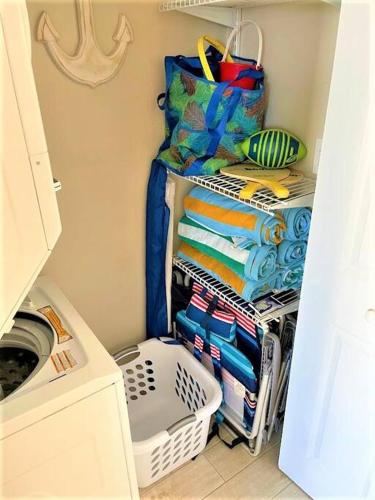 a laundry room with a drying rack with towels at Beachfront Retreat- "The Getaway" in Destin