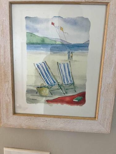 a painting of two chairs and a kite on a beach at Beachfront Retreat- "The Getaway" in Destin