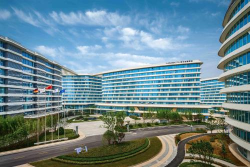 a large building with a street in front of it at The QUBE Hotel Shanghai Hongqiao in Shanghai