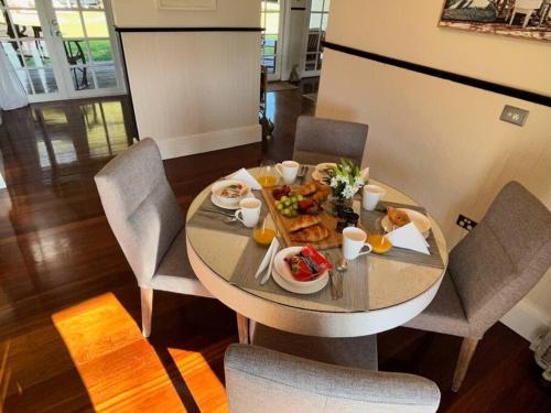 a table with plates of food on top of it at Secluded rural retreat in Southwest WA in Capel