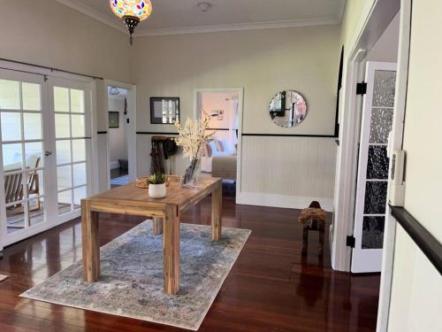 a living room with a wooden table on a rug at Secluded rural retreat in Southwest WA in Capel