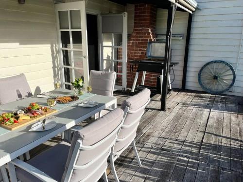 a table and chairs on a patio with a piano at Secluded rural retreat in Southwest WA in Capel