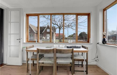 a kitchen with a table and chairs and a window at 4 Bedroom Gorgeous Home In Aakirkeby in Vester Sømarken