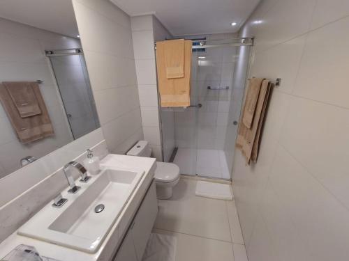 a bathroom with a sink and a toilet and a shower at Solar Tambaú - Loft sun and sea - ANÚNCIO NOVO in João Pessoa