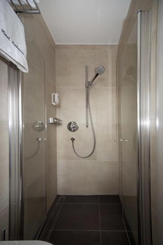 a shower in a bathroom with a glass door at Hotel Katharina Garni in Tübingen