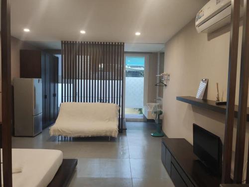 a room with a bed and a television in it at Morden Bathtub Apartment in Ho Chi Minh City