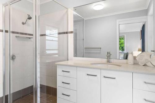 biała łazienka z umywalką i prysznicem w obiekcie Waterford House w mieście North Creek