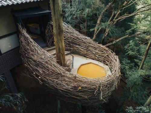 a bird nest with a yellow inside of it at Arimasansoh Goshobessho in Kobe