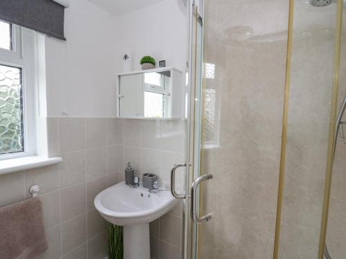 a bathroom with a sink and a shower at Melbourne House in Aberaeron