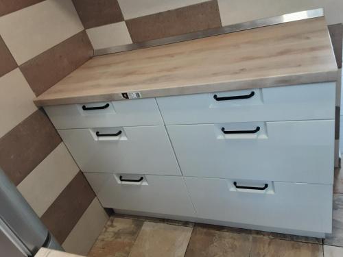 a kitchen with white cabinets and a counter top at Villa PANORAMA in Pag