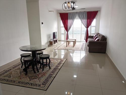 a living room with a table and chairs and a couch at Jannah Homestay Seruling in Putrajaya