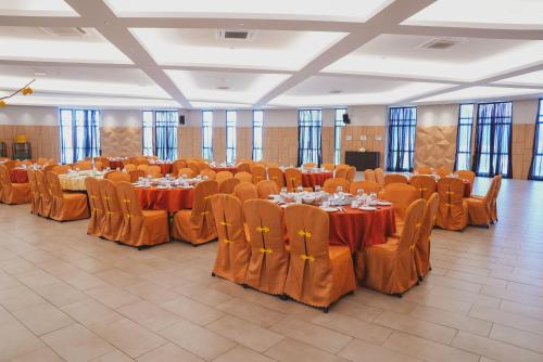 a large banquet hall with tables and chairs at Roxy Hotel Serian in Serian