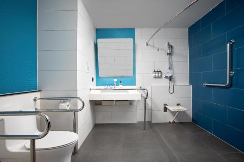 La salle de bains est pourvue d'un lavabo, de toilettes et d'un miroir. dans l'établissement Holiday Inn Express Shanghai Tangzhen, an IHG Hotel, à Shanghai