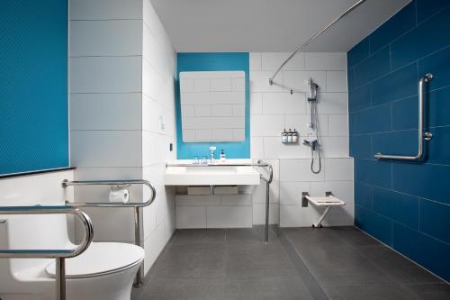 a bathroom with a sink and a toilet and a mirror at Holiday Inn Express Shanghai Tangzhen, an IHG Hotel in Shanghai