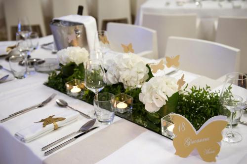 a table with white flowers and candles on it at Mec Paestum Hotel in Paestum